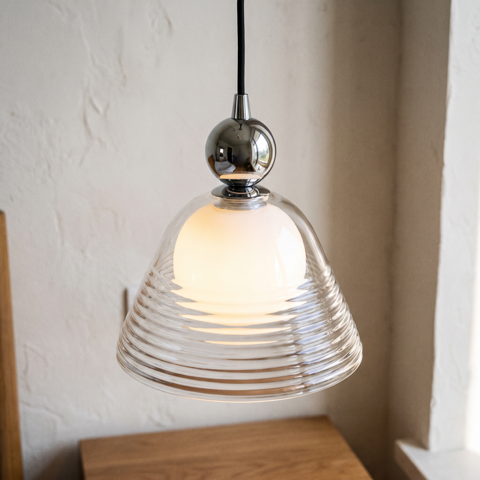 Close view of the Hedda ribbed glass pendant light showing the clear ribbed outer bell, opal inner globe and polished chrome ball