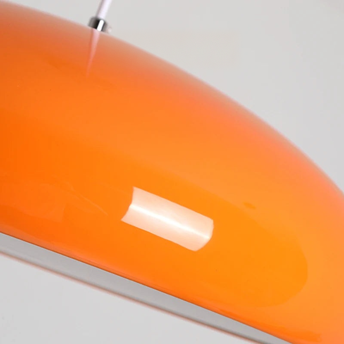 Orange dome pendant light close-up — glossy lacquer shade and slim adjustable cord